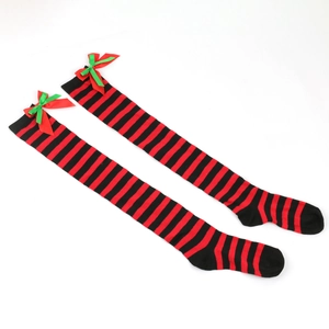 Detail of red and black striped over-the-knee socks with festive bow knot accents