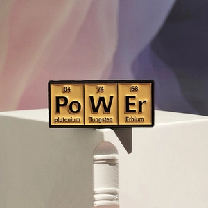 Creative chemistry periodic table metal enamel pin forming the word POWER in yellow