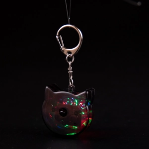 Glow-in-the-dark cat shaped keychain with multi-color LED lights and silver D-ring