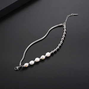 Detail showing irregular freshwater pearls and silver snake chain of the steel bracelet