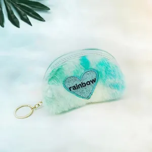 Detail view of tie-dye plush mini coin purse with heart patch and rainbow embroidery