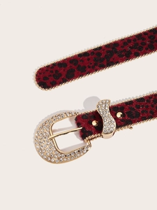 Close-up of red leopard print belt with rhinestone buckle and gold beaded edges