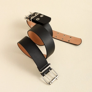 Detail view of black leather rivet belt with dual silver buckles and metal eyelets