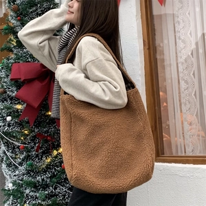 Close-up of fluffy brown teddy tote bag with soft texture for winter commuting