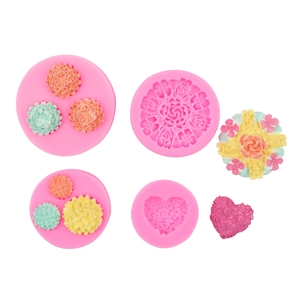 Pink silicone flower and heart molds set for DIY clay and cake decoration on white background