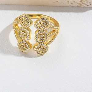 Detail of adjustable gold ring with geometric micro-pave clear zircon on stone surface