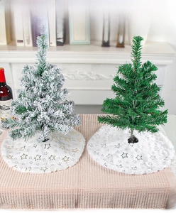 Mini Christmas tree with white faux fur tree skirt featuring gold star patterns