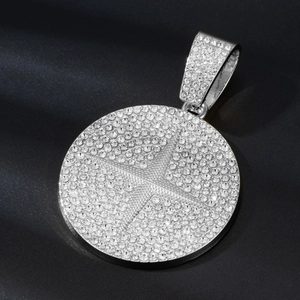 Macro detail of silver-colored hip-hop medallion with micro-pave crystals and starburst