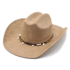 Detailed close-up of a khaki suede cowboy hat featuring tribal shell and bead embroidery