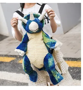 Detail of cute tricot dinosaur plush backpack with blue tie-dye fabric and adjustable straps