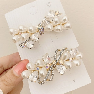 Elegant gold butterfly hair clips set with white pearls and AB crystals in Korean style
