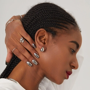 Elegantly designed water drop stainless steel ring and earrings set on a female model