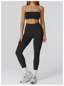 Detail of high-waist seamless black yoga leggings with tummy control and compression fabric