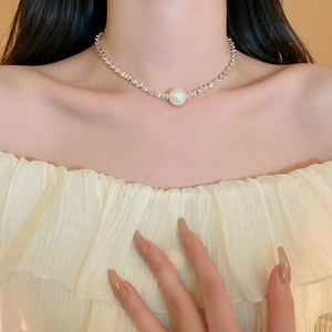 Minimalist silver choker necklace with twisted chain texture and large white faux pearl
