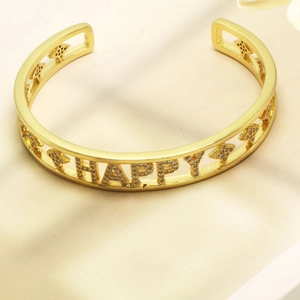 Macro view of gold plated Happy letter bracelet with sparkling zircon inlay details