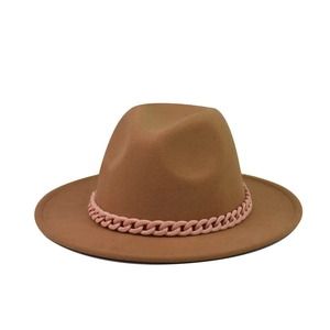 Detail of coffee brown wide brim wool fedora hat with stylish pink plastic chain band