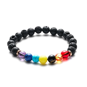 Macro shot of black lava rock beads and seven chakra colored stones with rose gold spacers