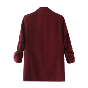 Detailed back view of wine red blazer jacket featuring elegant ruched sleeve design