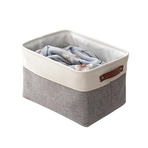 Grey and beige cotton linen storage basket with leather handles for blanket organizing
