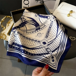 Blue and white silk square scarf with classic chain and unicorn print held by hand