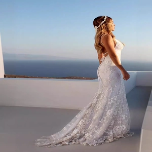 Elegant white lace wedding gown with floral embroidery, thin straps and a long train