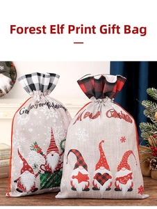 Close-up of linen Christmas gift bags with plaid trim and gnome print on wood table
