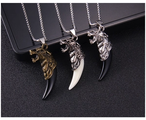 Three vintage faux wolf tooth pendant necklaces in bronze and silver finishes displayed together
