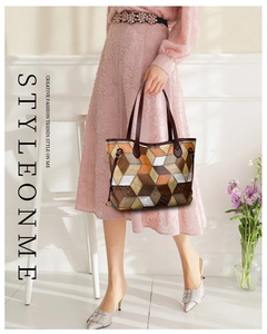 Detail of color-block geometric tote bag with textured faux leather and long handles
