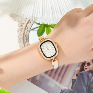 Elegant oval rose gold ladies watch with crystal bezel and white leather strap