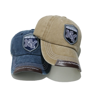 Vintage NY letter baseball caps in navy and khaki with leather brim detail