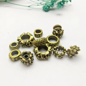 Vintage bronze wreath spacer beads with intricate hollow patterns on white background