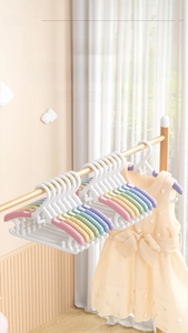 Close-up of colorful non-slip children clothes hangers in soft macaron rainbow colors