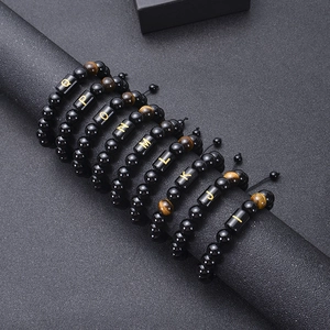 Detailed close-up of adjustable black onyx and tiger eye stone letter bead bracelets
