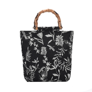 Floral jacquard canvas tote bag with natural bamboo handles and white botanical patterns