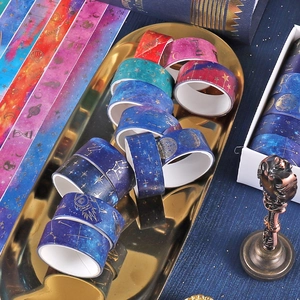 Starry sky galaxy theme washi tape set with gold foil constellations on a metal tray