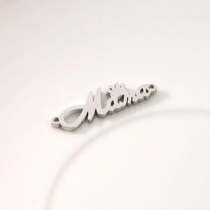 Macro detail of silver stainless steel Mama cursive charm with crown and dual connectors