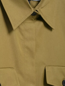 Detail of khaki twill fabric shirt with resin buttons and precise stitching lines