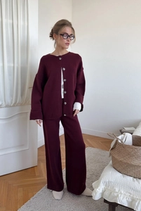 Full-body shot of a dark burgundy knit cardigan and wide-leg pants two-piece set
