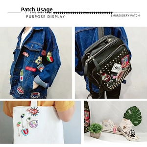 Detail of round embroidered patches applied to denim jackets, bags and high-top sneakers