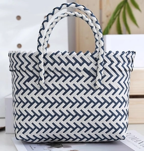 Detail of blue and white hand-woven basket featuring sturdy round handles and textured finish