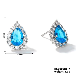 Macro detail of teardrop blue zircon earrings with silver setting and dimension specs