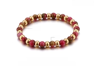 Detail of 6mm faux garnet and 18K gold plated beads on a flexible beaded bracelet