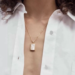 18k gold plated titanium necklace with rectangular white shell pendant on model