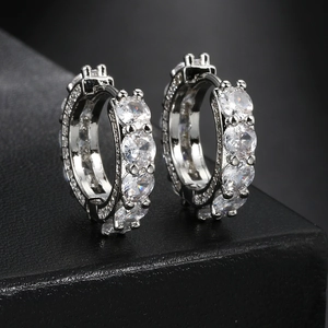 Silver hip hop hoop earrings with micro-pave round zircons on black leather texture