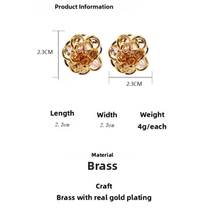 Detail view of blue crystal flower earrings with 2.3cm measurement and brass gold plating