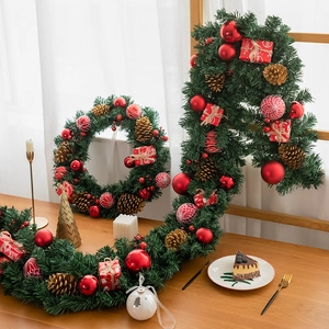 Christmas wreath and garland set with red ornaments and pine cones for festive holiday decor