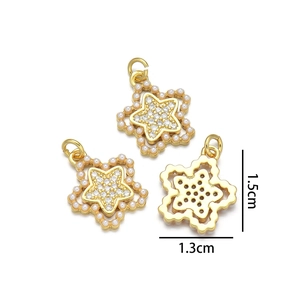 Detail showing 1.5x1.3cm gold star pendants with micro-paved zircons and small pearls