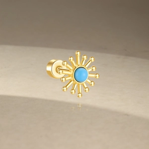 Macro shot of 925 silver gold stud earring with turquoise stone and screw back detail