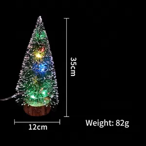 Mini pre-lit Christmas tree with colorful LED lights, snow dusting and wood base