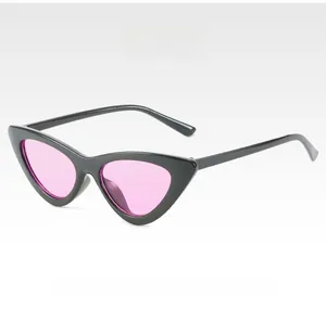 Detail of trendy cat-eye sunglasses with thick black frame and pink transparent lenses